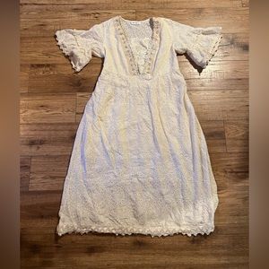 White, eyelet lace midi dress with short bell sleeves and lace front piece.
